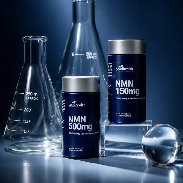 Three dark blue supplement bottles labeled GoodHealth NMN 500mg, NMN 150mg, and a large flask in the background, styled on a reflective dark blue surface with glassware and a clear sphere.